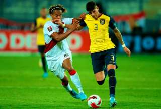 Piero Hincapié (der.) protege el balón ante el peruano André Carrillo